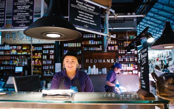 Redmans trader behind counter