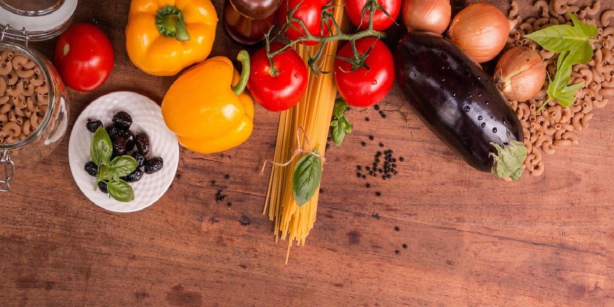 A range of food including pasta on a wooden board