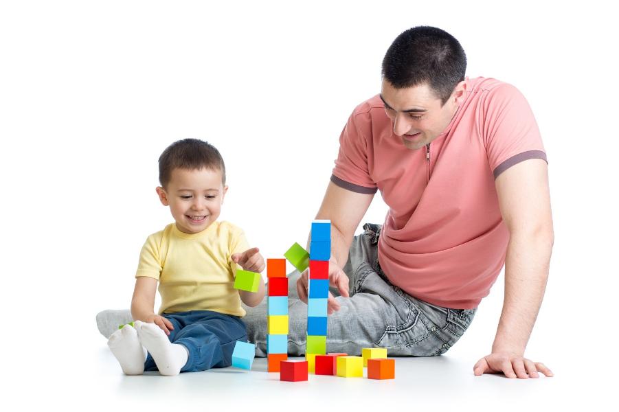 Building blocks with Dad Man playing building bricks with his young boy
