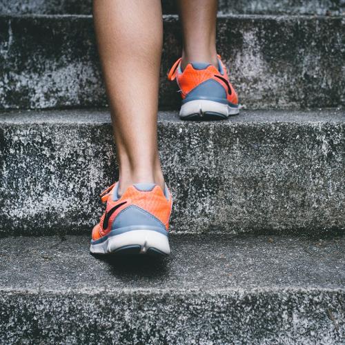 A person running up some concrete steps 